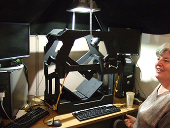 Ms. Graham with the book photographing device she designed